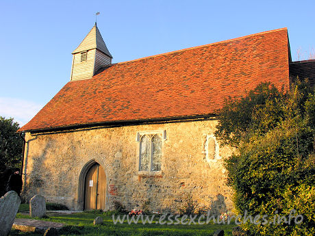 All Saints, Vange Church - The S wall of the church, showing the S door, and the blocked 
Norman window.

