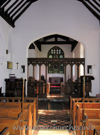 All Saints, Nazeing Church - The chancel arch, with screen. The two strange objects to either side of the arch are the remains of the rood screen supporting structure. Higher, and to the left, can be seen the remains of the rood beam.